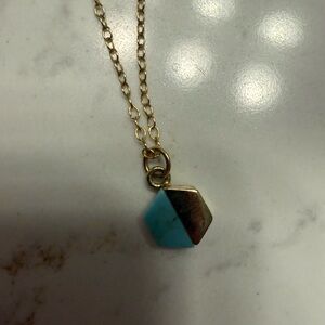 Gold tone necklace with turquoise pendant